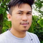 cdn-storyteller_jayson-palolan-1 Jayson with two indigenous instruments; the jaw harp and nose flute, in Kent Park. Photo Credit: Phyllis Lewis